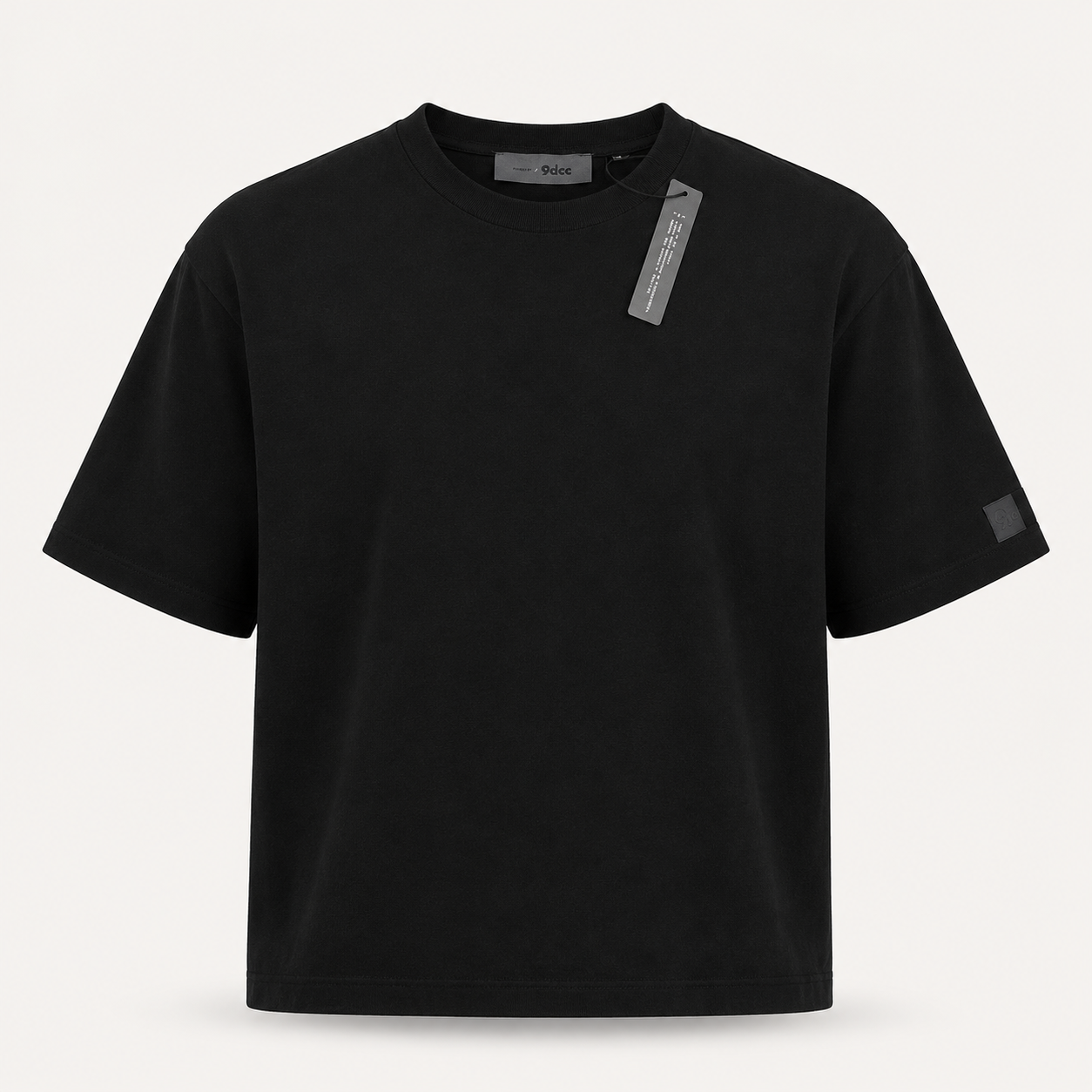 Premium 9dcc deadstock black luxury streetwear T-shirt featuring a clean minimalist layout with a tonal square logo patch near the front hemline.