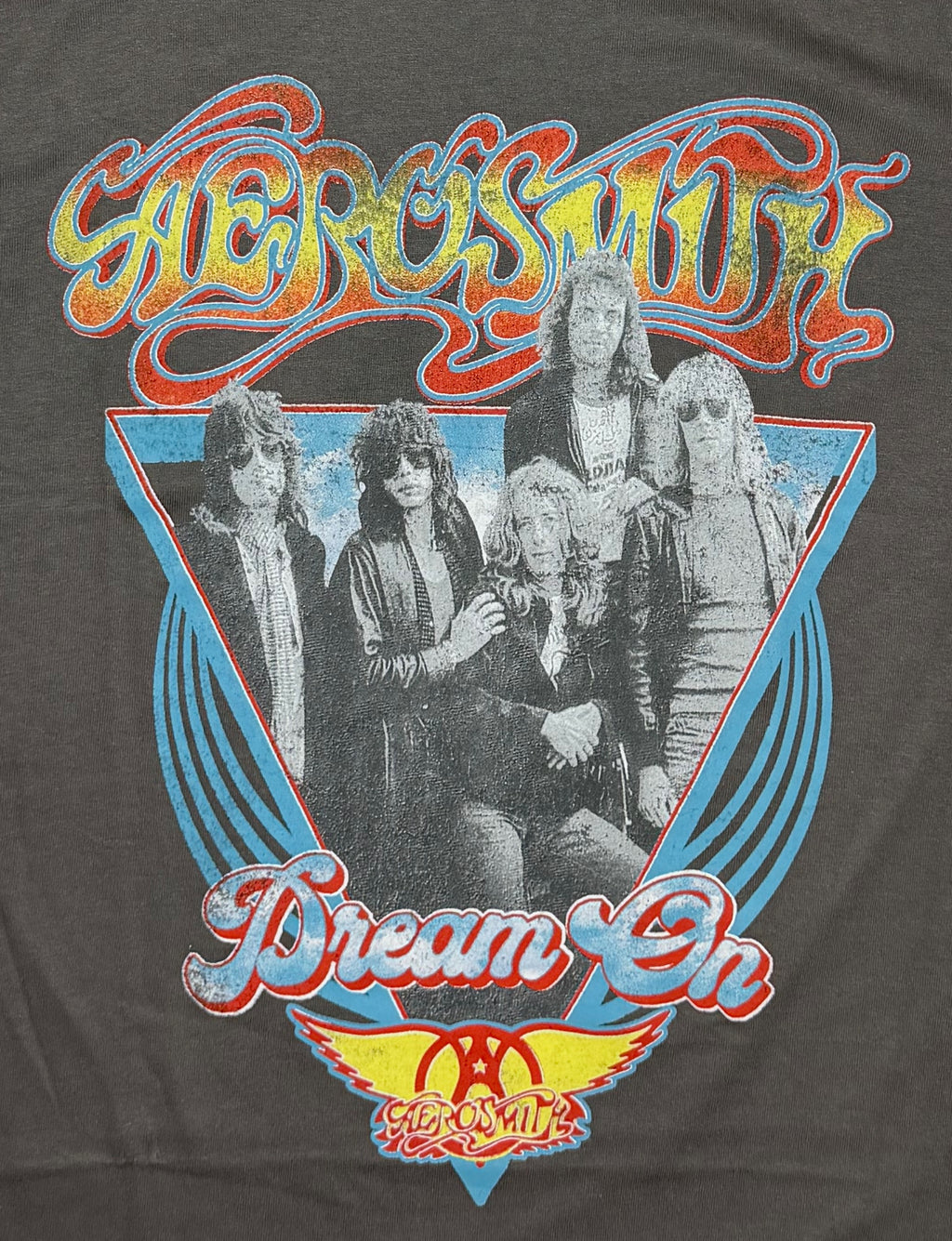 Official Aerosmith rock band grey T-shirt featuring a colorful retro front graphic with a band portrait layered over a blue triangle layout.