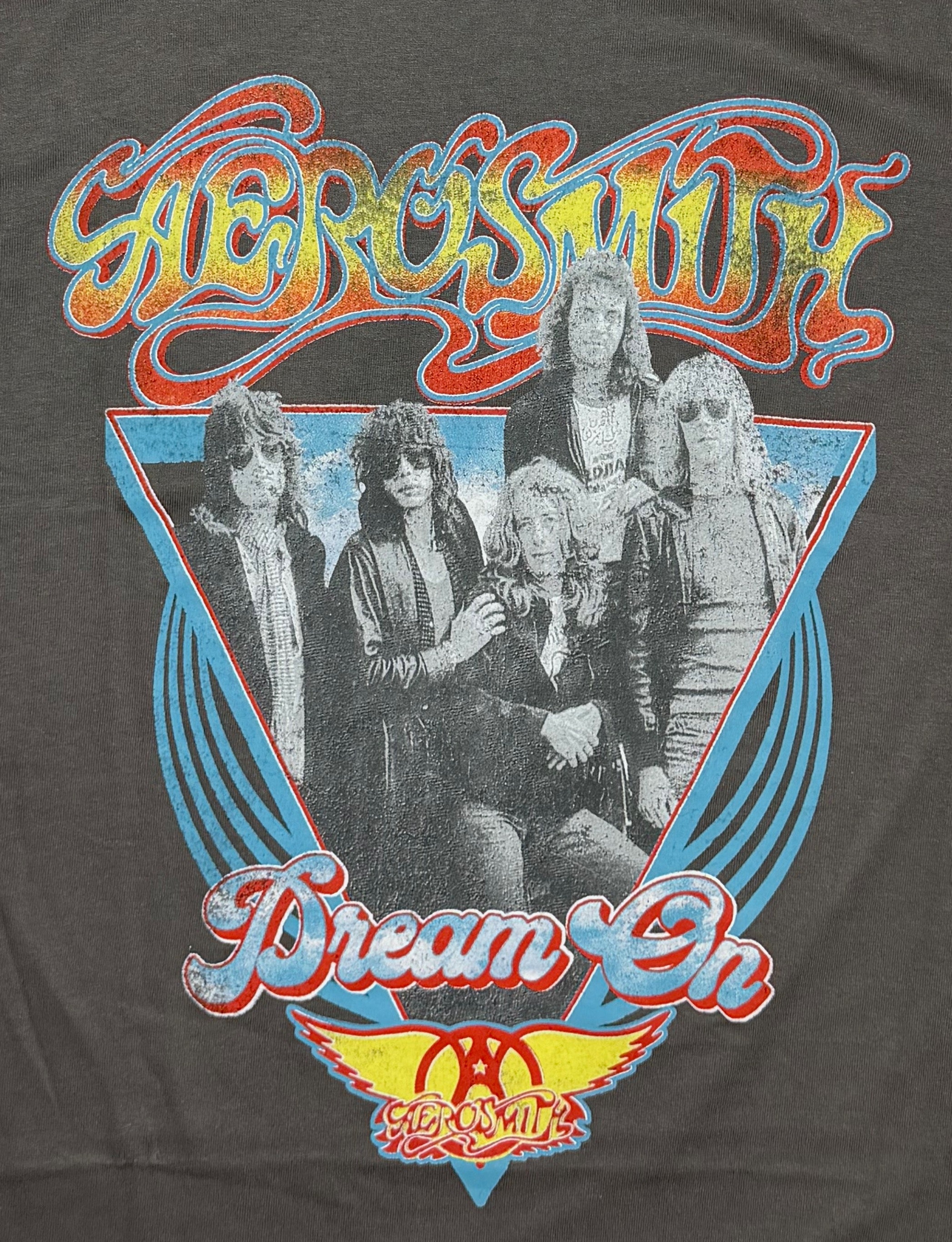 Official Aerosmith rock band grey T-shirt featuring a colorful retro front graphic with a band portrait layered over a blue triangle layout.