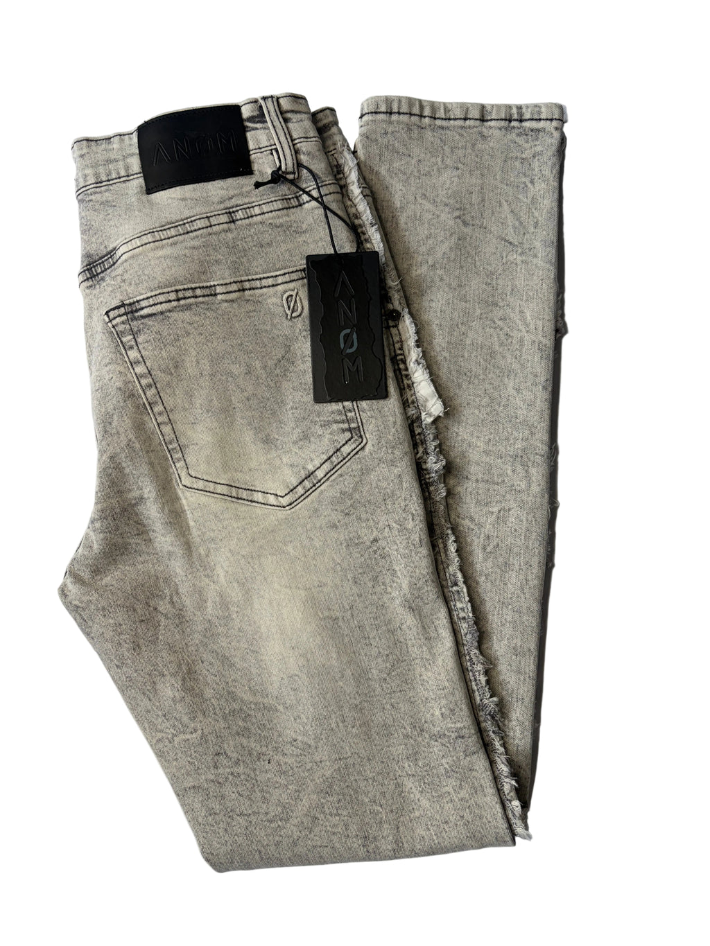 Alternate back layout of AMNÉ modern streetwear denim jeans in a textured grey acid wash. Displays heavily distressed frayed side seams, a signature black leather logo patch, and branded hang tags.