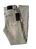Alternate back layout of AMNÉ modern streetwear denim jeans in a textured grey acid wash. Displays heavily distressed frayed side seams, a signature black leather logo patch, and branded hang tags.