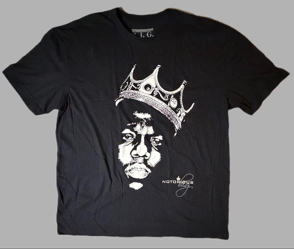 Front flat lay view of an official licensed black Biggie Smalls unisex graphic t-shirt featuring the iconic King of New York portrait of Christopher Wallace wearing a tilted crown.