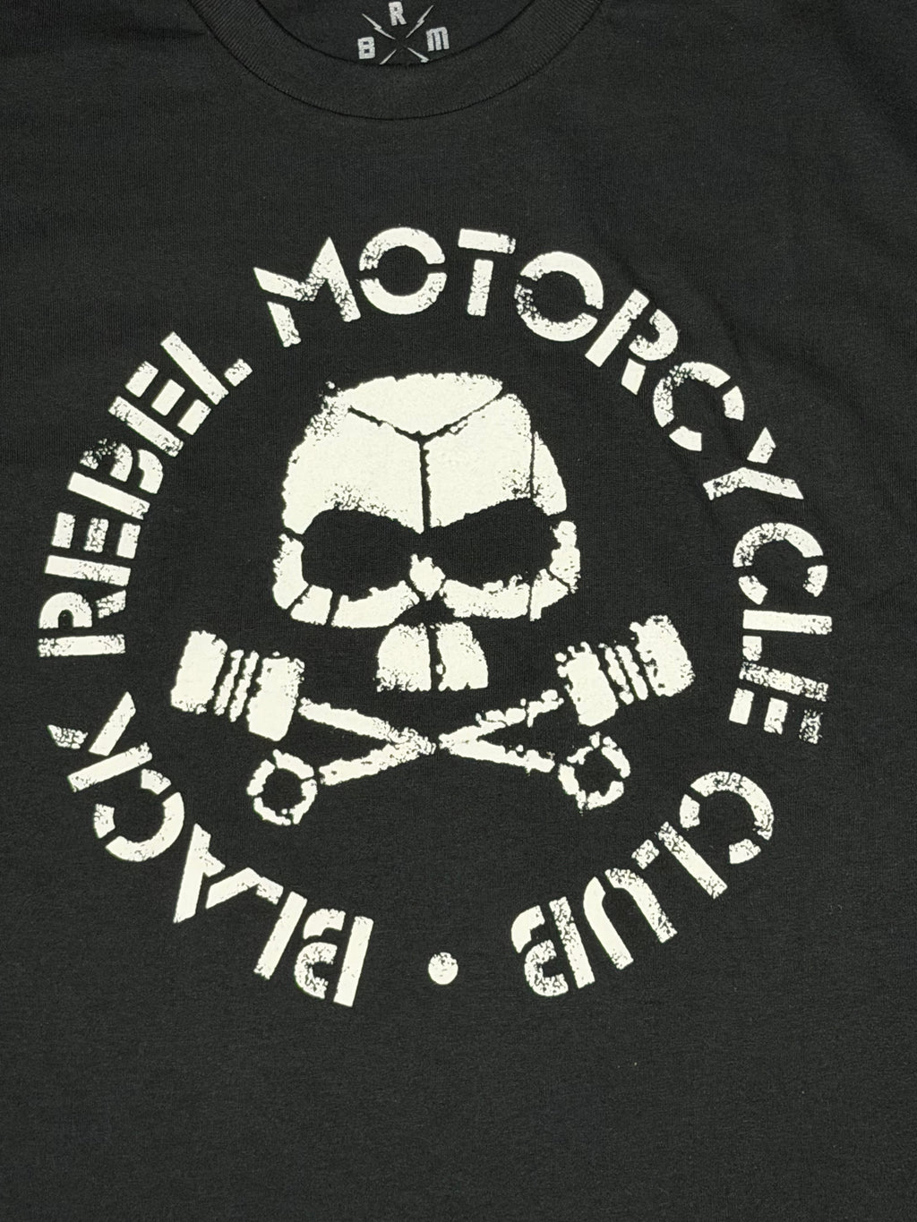Official Black Rebel Motorcycle Club black T-shirt featuring a high-contrast white circular logo with a skull and crossed pistons.