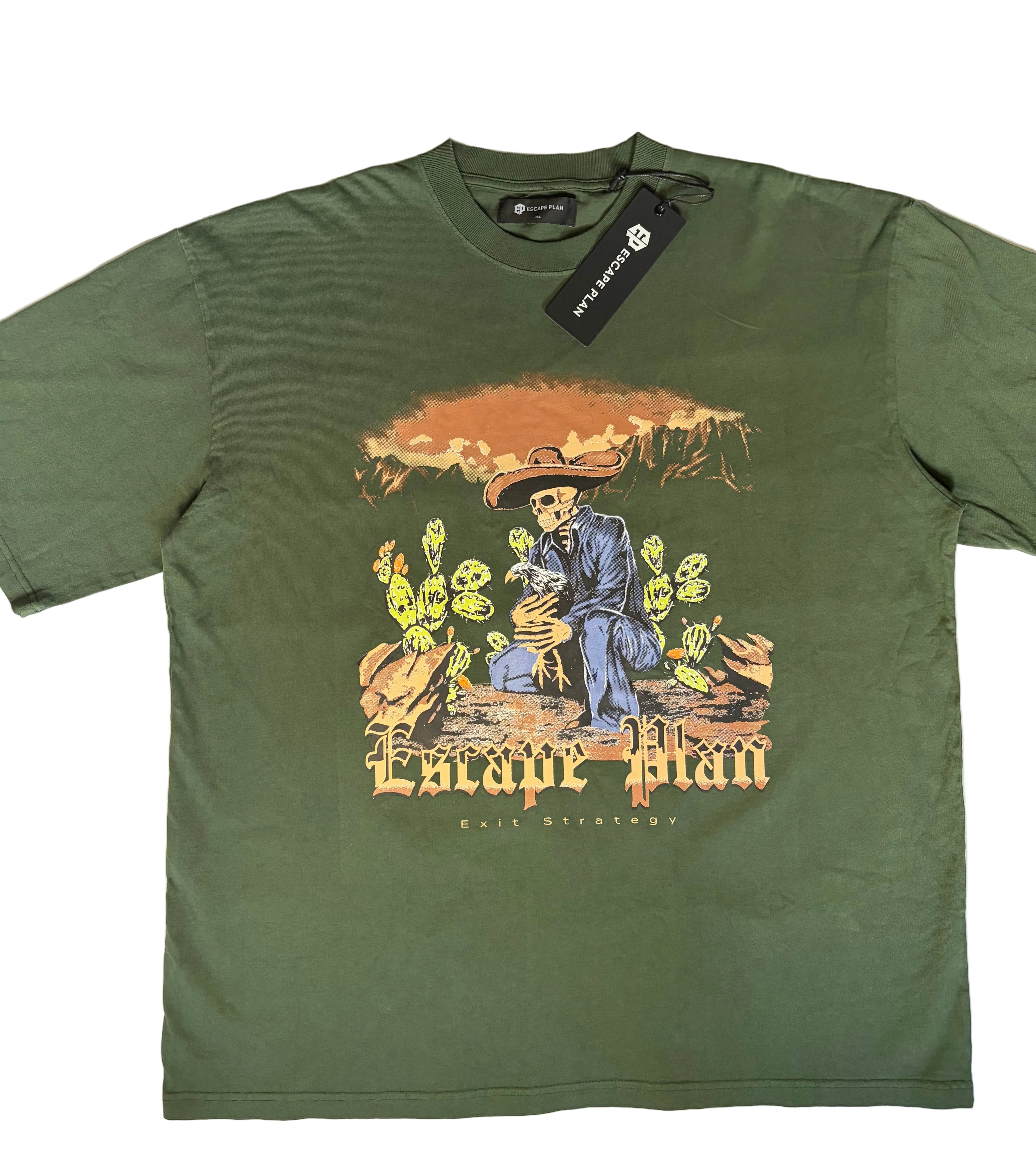 Escape Plan graphic tee in olive green streetwear style. Features a detailed desert scene with a skeleton in a sombrero, neon yellow cacti, and "Exit Strategy" gothic typography. Brand tags attached.