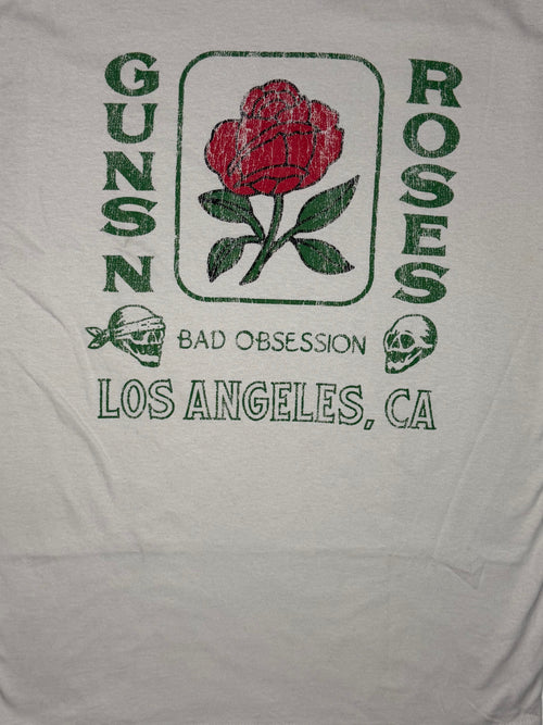 Official licensed Guns N' Roses stone-colored T-shirt featuring a red rose graphic with Bad Obsession and Los Angeles California typography.