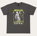 Front flat lay view of an official licensed Metallica unisex short-sleeve graphic t-shirt in charcoal grey, featuring the classic yellow logo, Lady Justice artwork, and four band portraits from the 1988 And Justice For All album era.