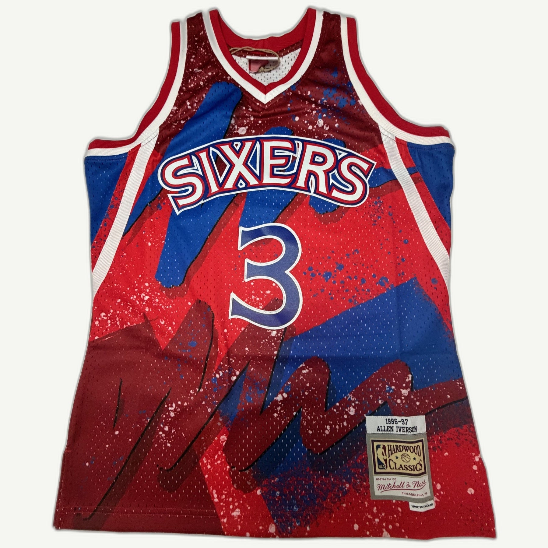 Mitchell & Ness Allen Iverson Philadelphia 76ers 1996-97 Hardwood Classics jersey with a sublimated red and blue splash graphic, featuring a stacked Sixers chest logo and number 3.