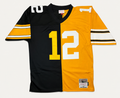 Mitchell & Ness Terry Bradshaw Pittsburgh Steelers 1976 Split Legacy replica football jersey featuring a half-black, half-gold vertically split design with number 12.