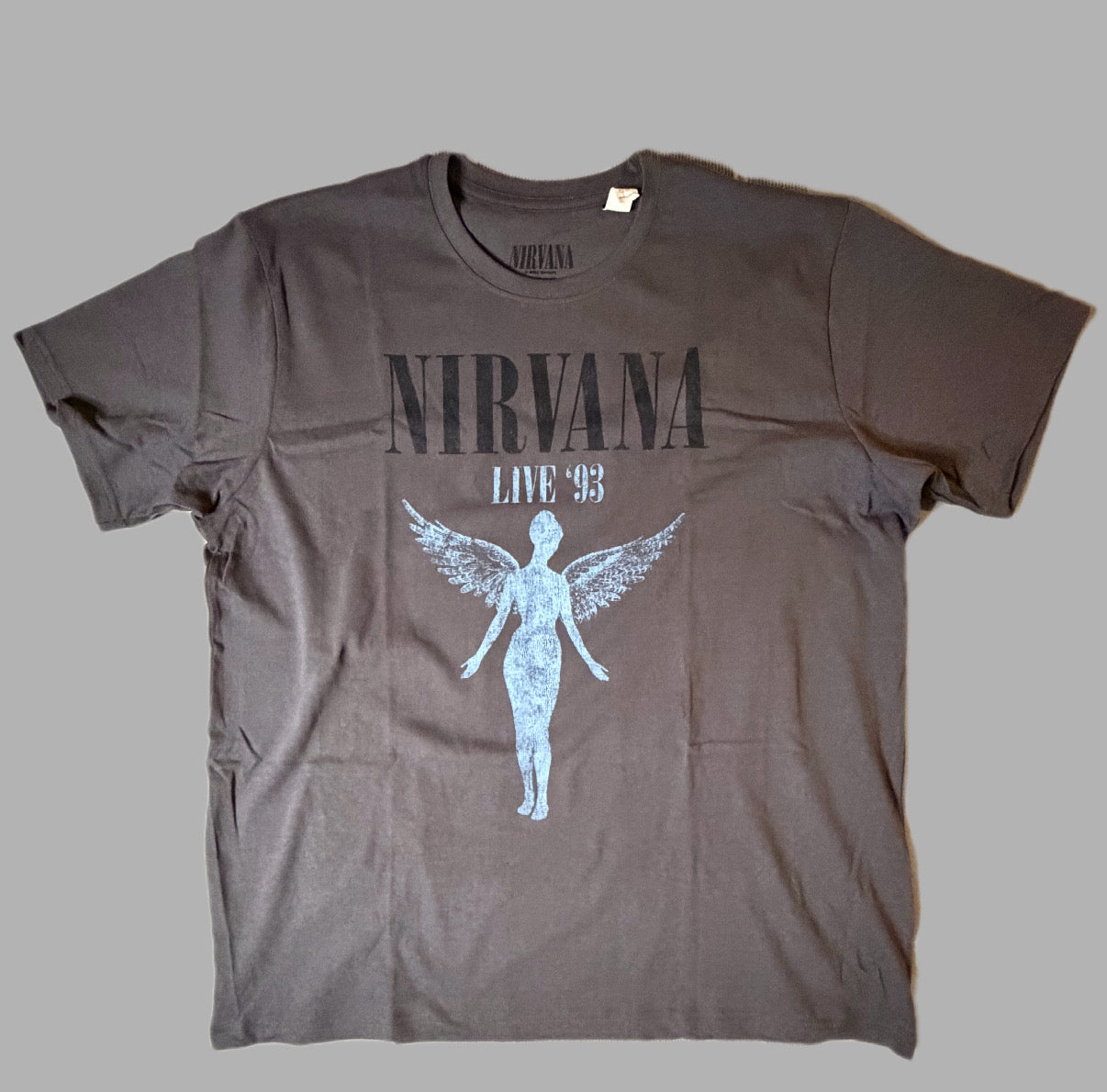 Front view of an official licensed Nirvana unisex short-sleeve graphic t-shirt in charcoal grey, featuring the classic In Utero winged anatomical angel design printed with Live 93 text.