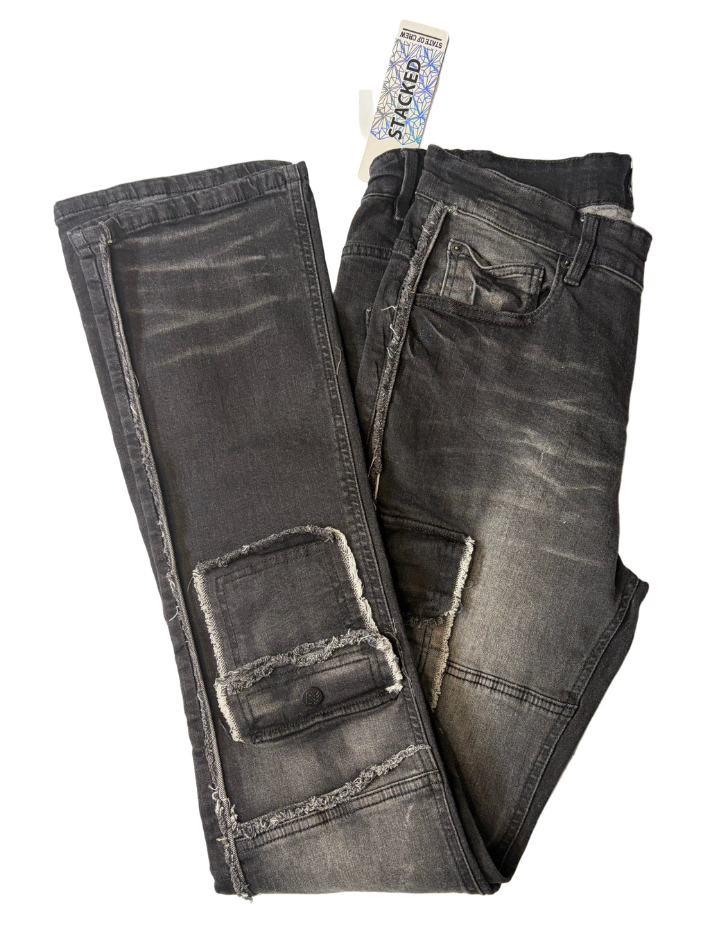 Alternate product view of Stacked modern streetwear cargo jeans in faded black charcoal denim. Displays distressed raw-edge accents, lower leg utility cargo pockets, heavy whiskering textures, and a white brand tag.