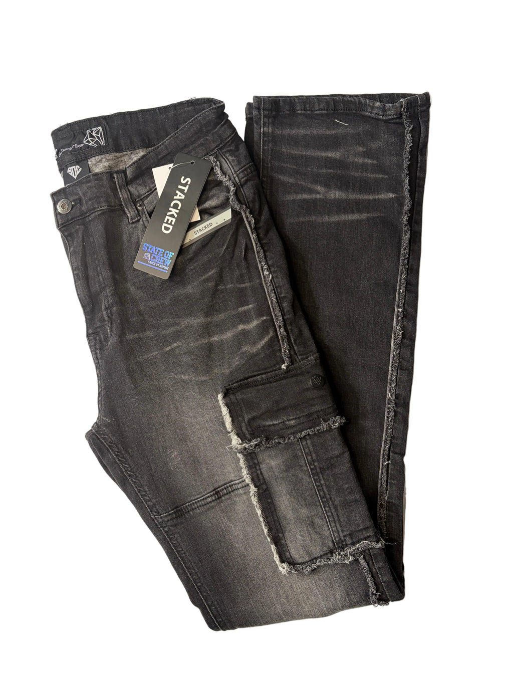 Stacked modern streetwear cargo jeans in a washed black charcoal denim finish. Features raw, frayed edge detailing, utility thigh pockets, a relaxed stacked leg silhouette, and original brand hang tags.