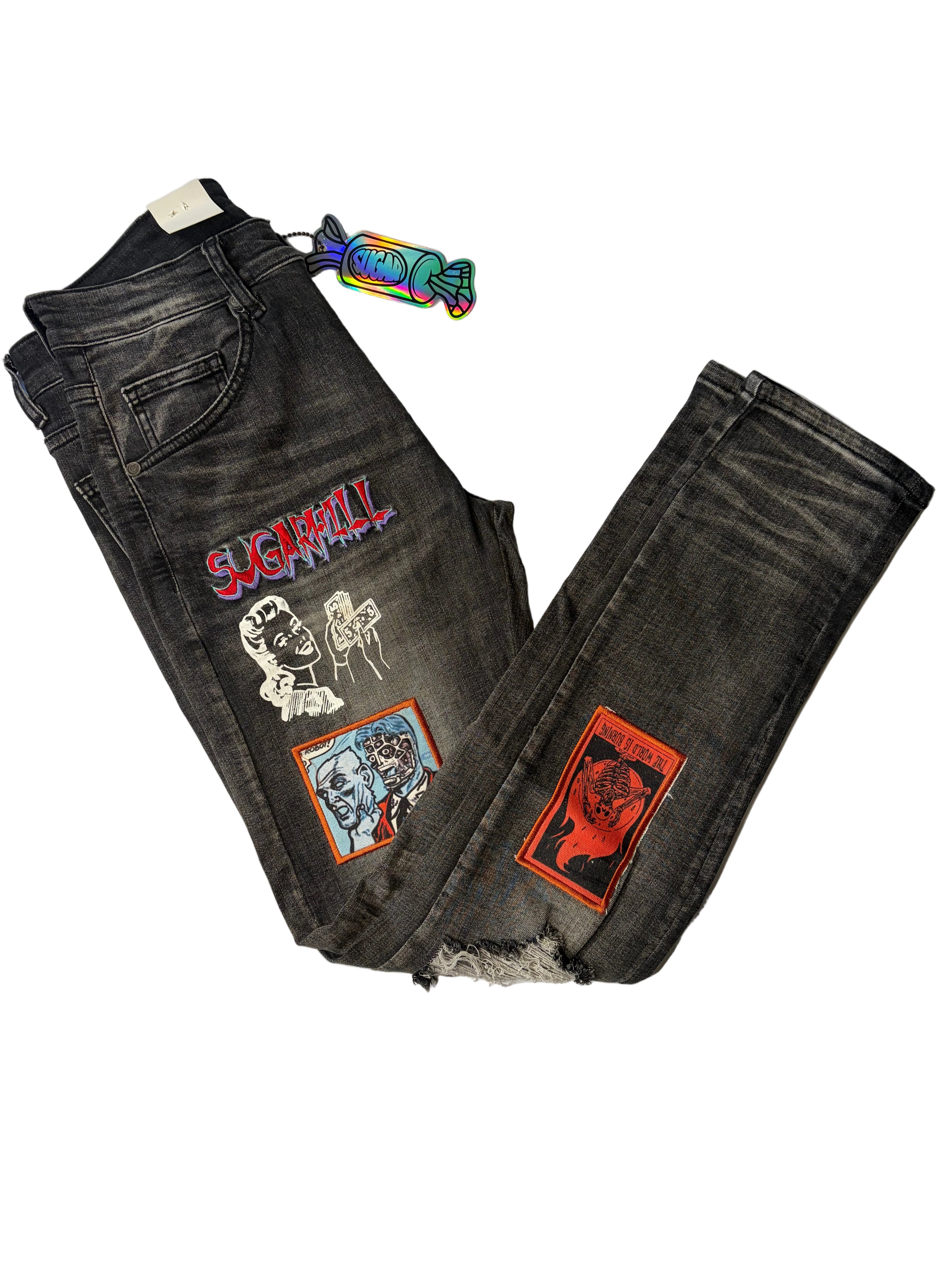 Sugarhill modern streetwear graphic denim jeans in dark wash black. Features red "Sugarhill" gothic embroidery, retro line art graphics, and colorful illustrated patches with a signature candy hang tag.