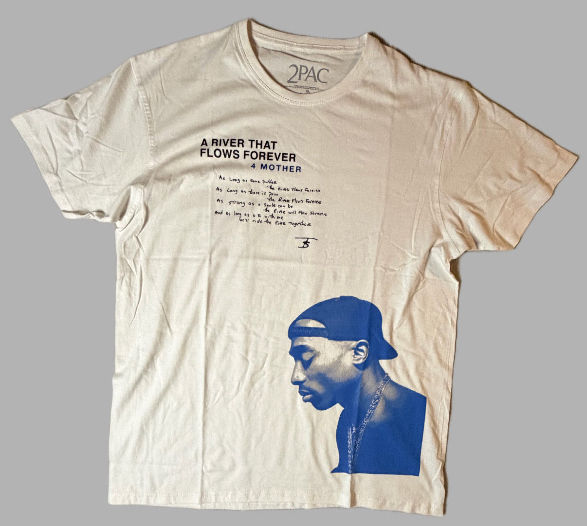 Front view of an official licensed white Tupac unisex graphic t-shirt featuring the A River That Flows Forever poem text script and a large blue-tinted portrait graphic of 2Pac.