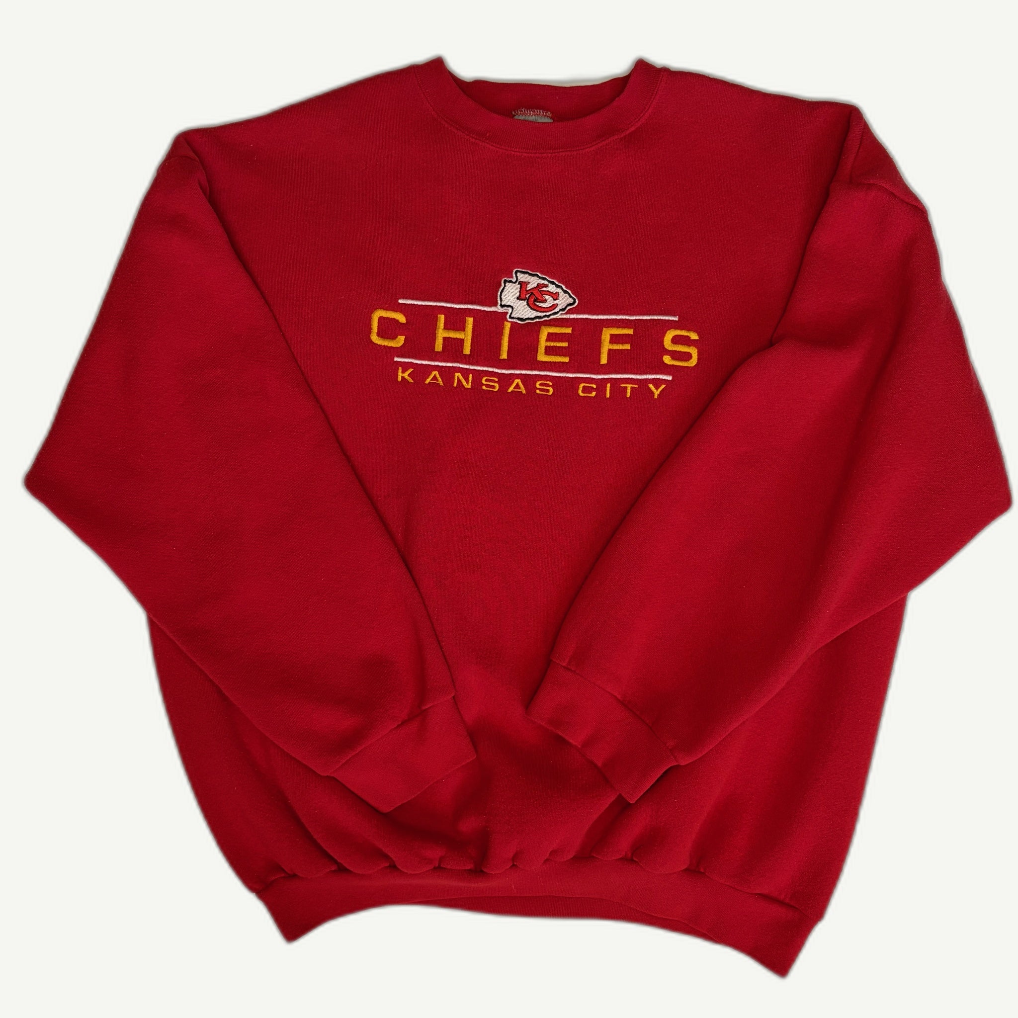 Front view and details of a vintage mid-1990s Kansas City Chiefs NFL red crewneck sweatshirt with embroidered arrowhead team shield logo and block typography by Logo 7