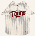 Front view of vintage mid-1990s Minnesota Twins MLB white button-up baseball jersey with midnight navy pinstripes and layered red tackle-twill script chest logo by Russell Athletic