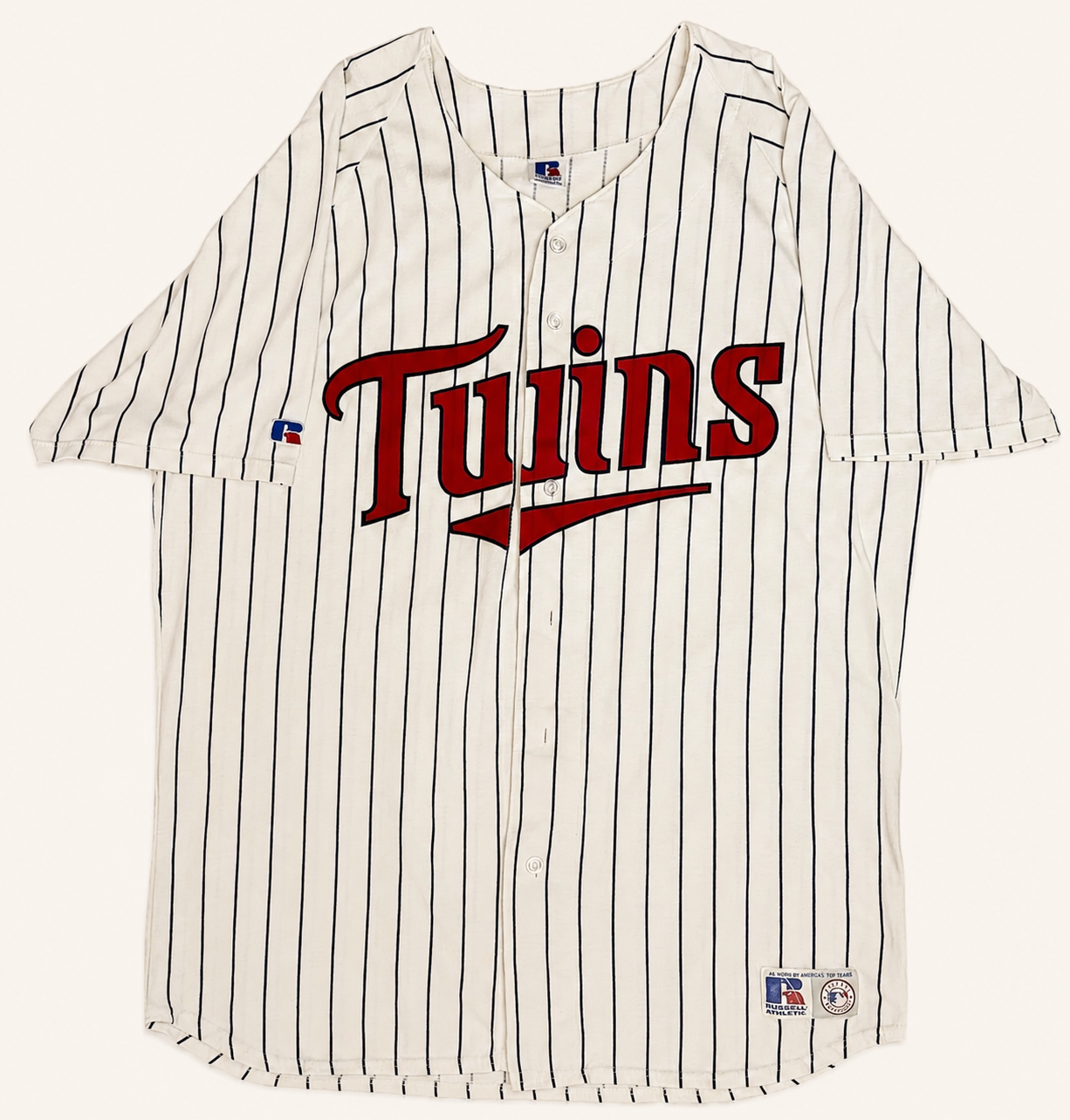 Front view of vintage mid-1990s Minnesota Twins MLB white button-up baseball jersey with midnight navy pinstripes and layered red tackle-twill script chest logo by Russell Athletic