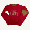 Front view of vintage mid-1990s San Francisco 49ers NFL heavyweight red crewneck sweatshirt with ribbed knit drop-shoulder stripes, metallic gold paneling, and direct-embroidered tackle-twill chest spellout by Starter