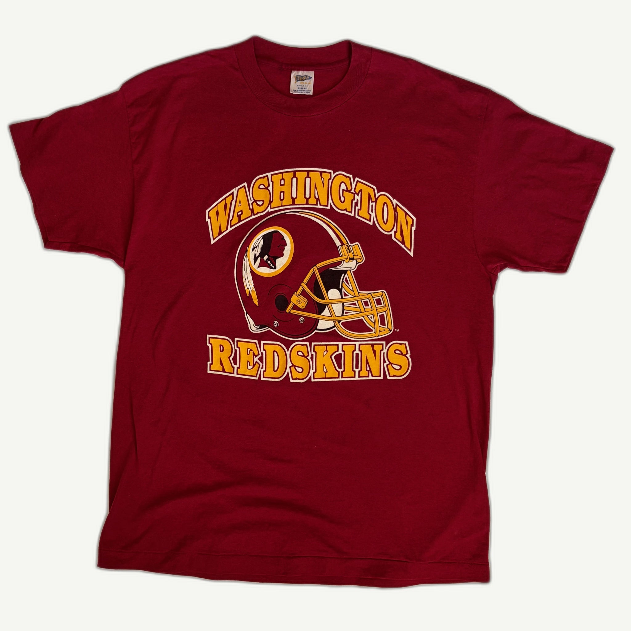 Front view of vintage early 1990s Washington Redskins NFL football single-stitched burgundy graphic tee with center-chest helmet screenprint by Trench Manufacturing Co