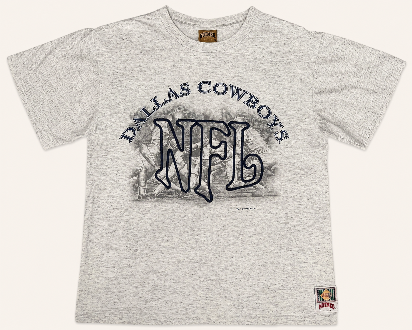 Front view of vintage 1993 Dallas Cowboys NFL heather grey graphic tee with a tackle-twill embroidered center emblem and monochrome sketch graphics by Nutmeg Mills