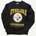 Front view of vintage 1997 Pittsburgh Steelers NFL heavyweight washed black crewneck sweatshirt with arched yellow spellout and central logo emblem by Lee Sport