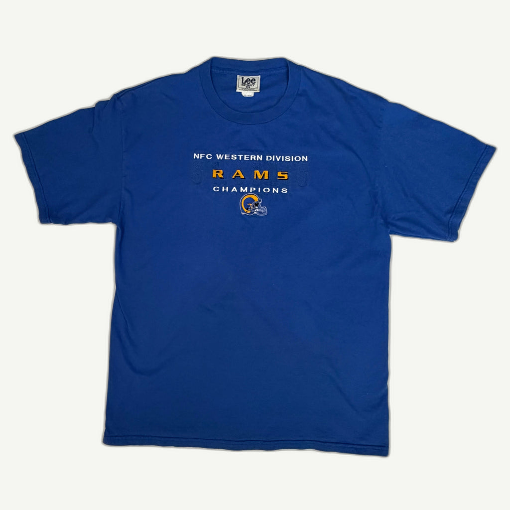 Front view of vintage 1999 St. Louis Rams NFC Western Division Champions royal blue graphic tee with embroidered helmet chest patch by Lee Sport