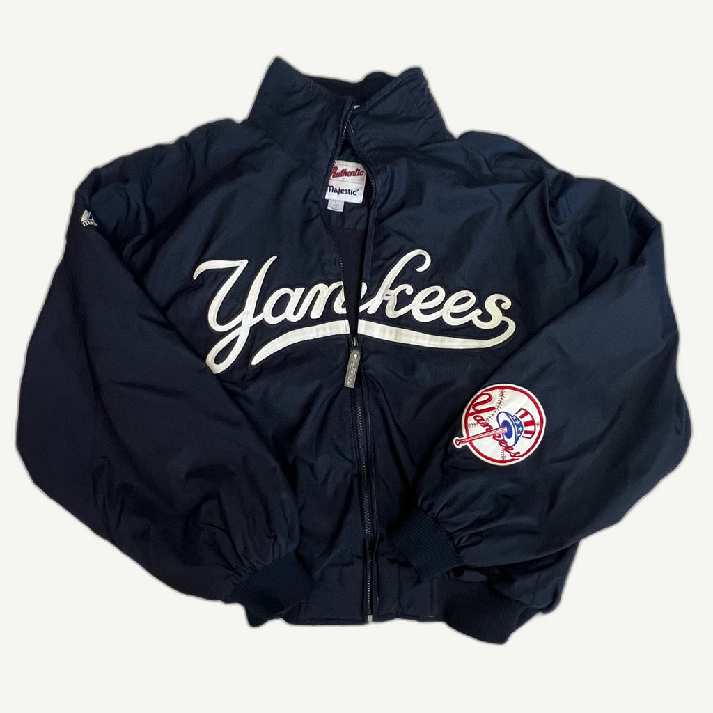Front and back view of vintage early 2000s New York Yankees MLB Authentic Collection full-zip dugout jacket by Majestic with white tackle-twill script embroidery