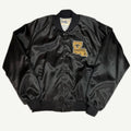 Front and back view of vintage 1980s New Orleans Saints NFL black nylon satin varsity jacket with chenille Louisiana state patch by Chalk Line