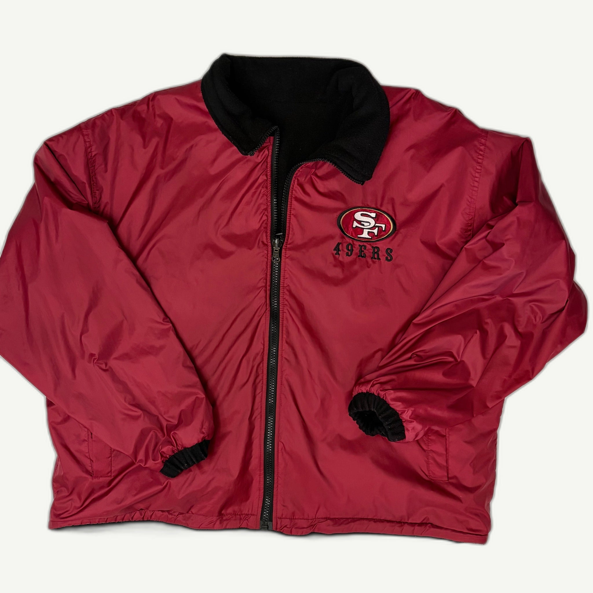 Front and back view of vintage 1990s San Francisco 49ers NFL reversible full-zip stadium jacket by Pro Player showing the embroidered SF logo